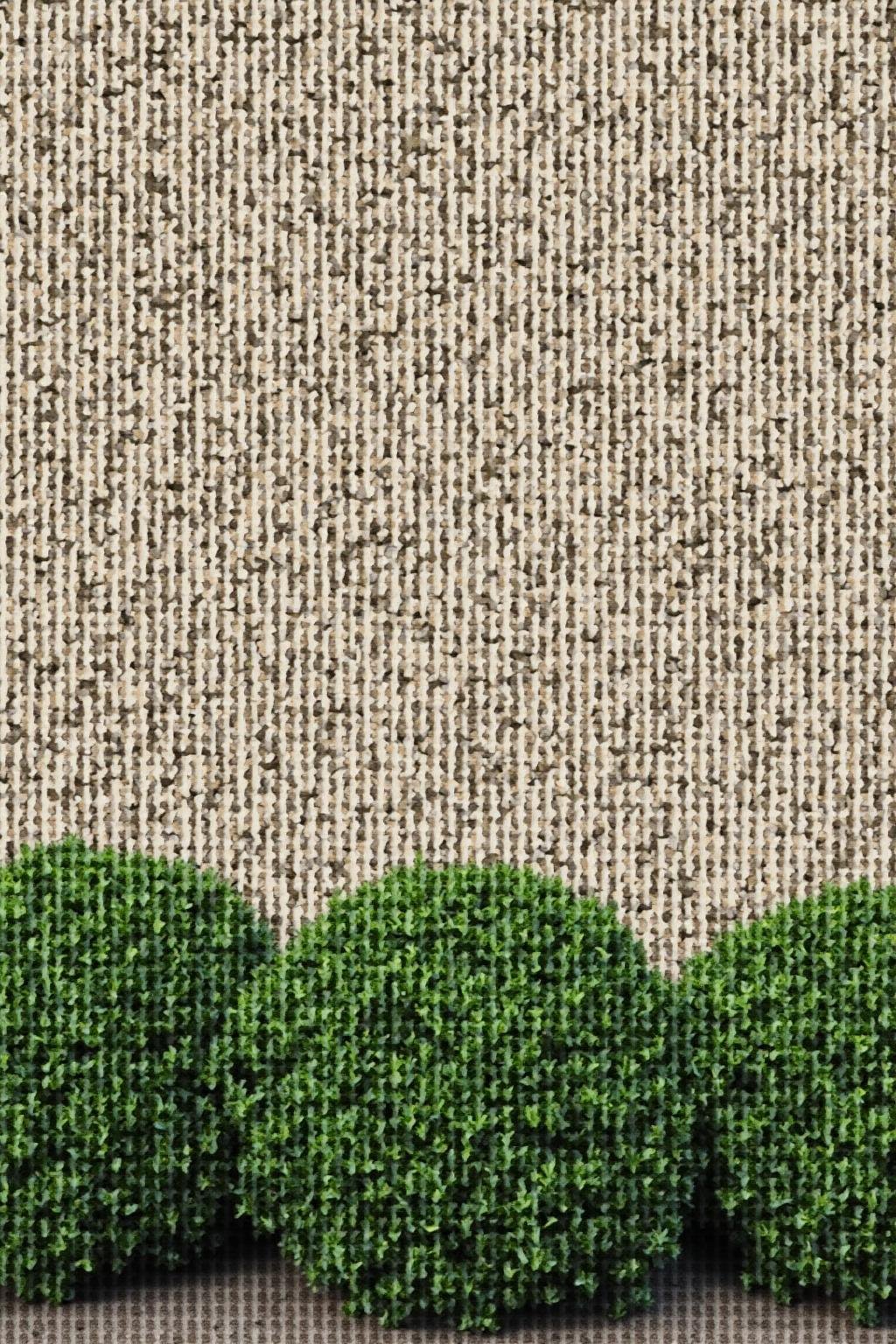 Elegant stone garden wall with detailed craftsmanship and greenery at the base