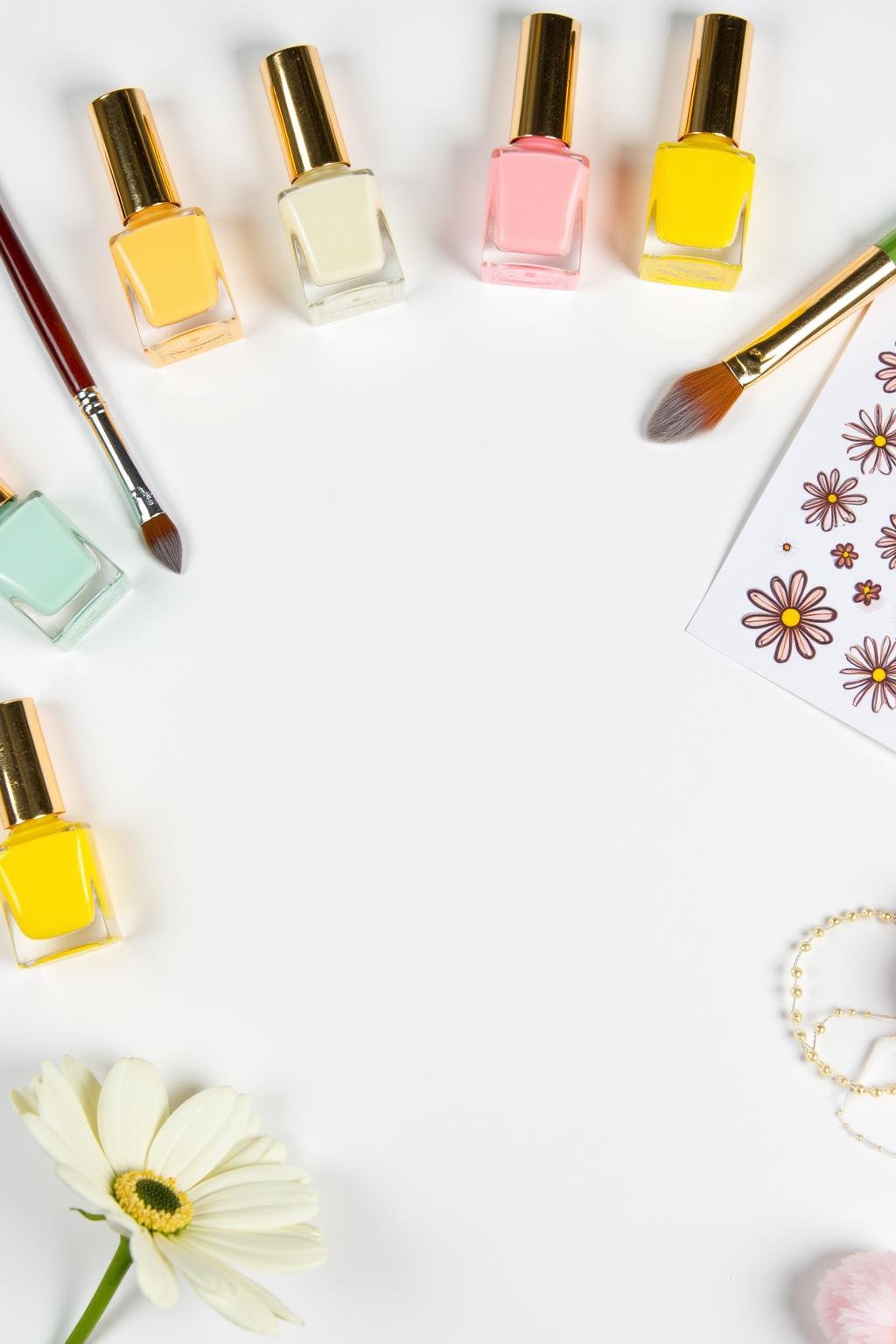 Flat lay photo of pastel yellow nail polish and nail art tools for summer nail designs